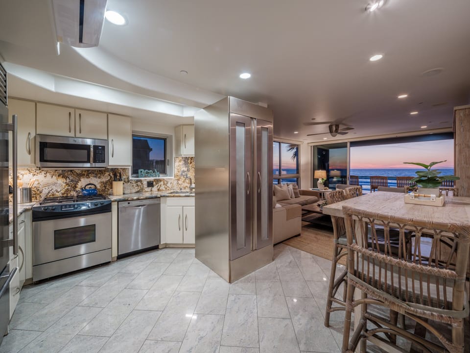 This sleek, spacious kitchen includes a charming dining area perfect for shared meals.