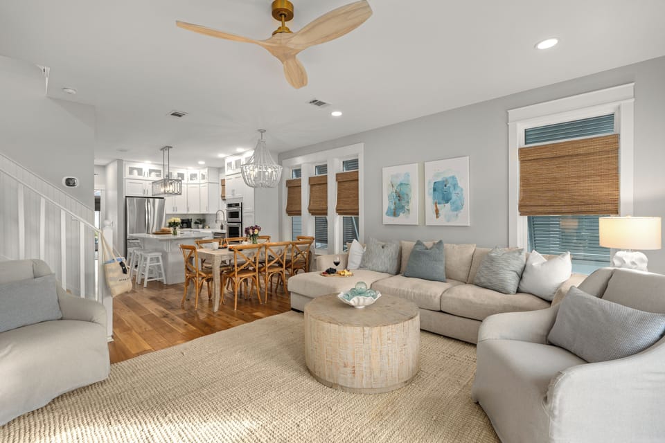 Open-concept living and dining area with high ceilings and natural light.