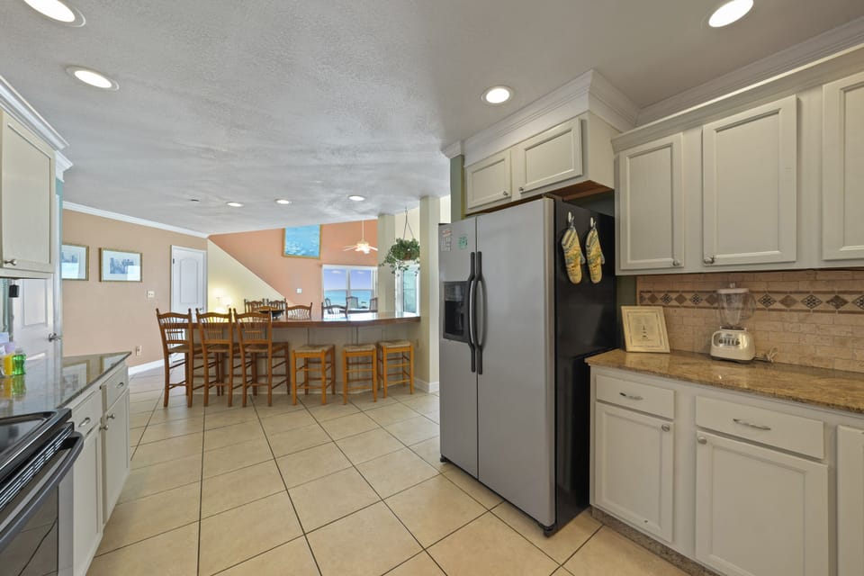 Spacious fully equipped kitchen with breakfast bar in Cabana Club Destin beachfront condo.