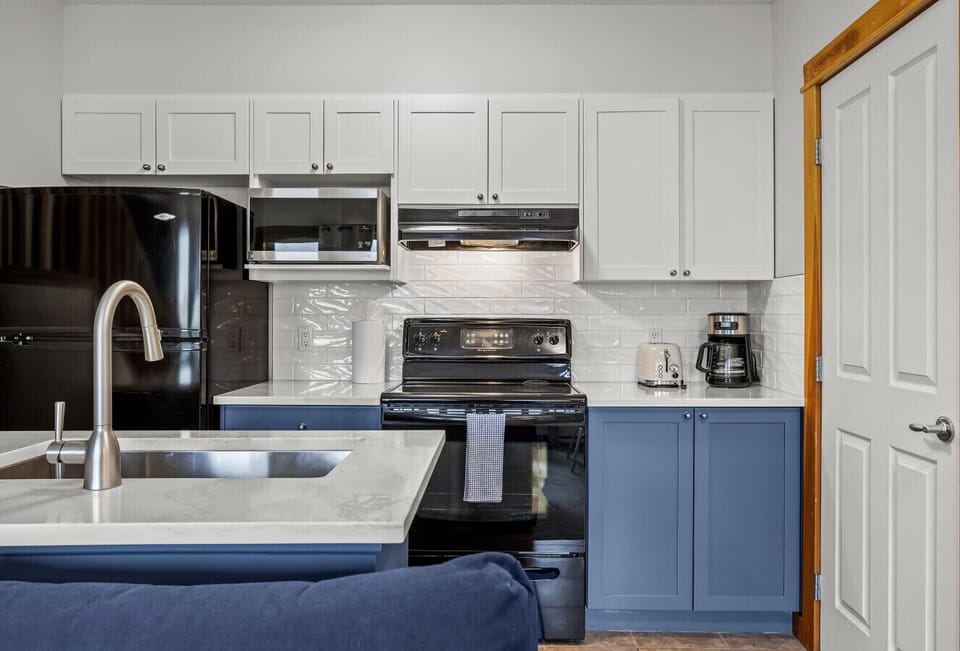 The bright, fully stocked kitchen is in-keeping with the cool blue colour scheme throughout