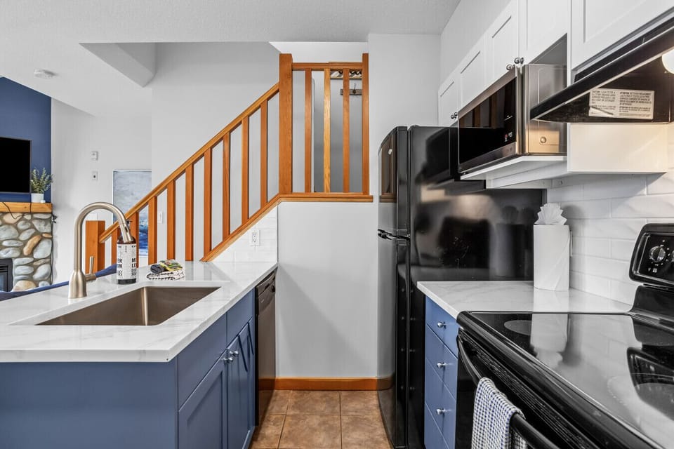 The bright, fully stocked kitchen is in-keeping with the cool blue colour scheme