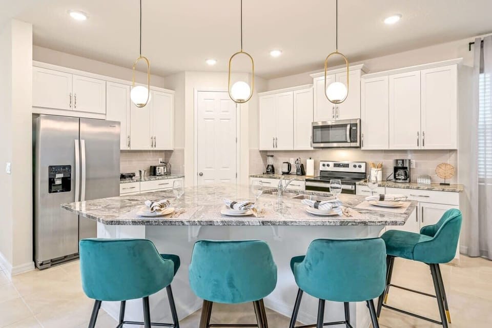 A superb center island breakfast bar with 4 plush bar stools.