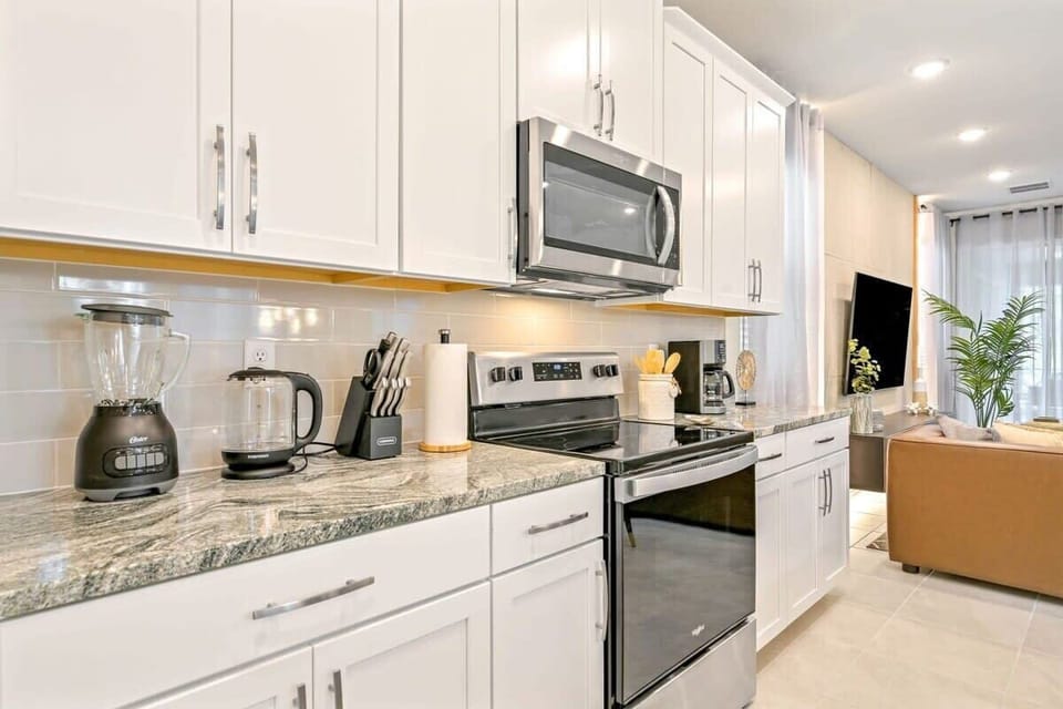 The fully-equipped kitchen includes all essential appliances for home-cooked meals.