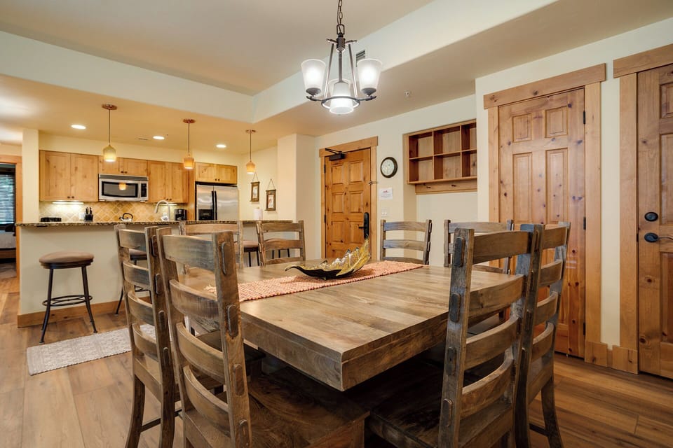 Gather around this rustic dining table where warm wood tones and mountain charm create the perfect setting for your group meals and memories.