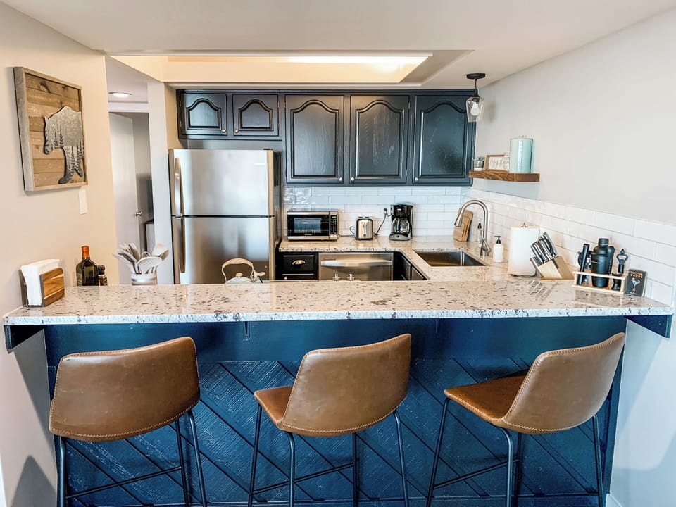 Three bar stools allow for socializing and cooking at the same time.