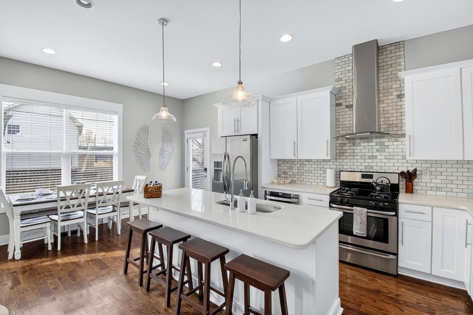 Modern kitchen, stainless appliances, quartz counters, island seating for four
