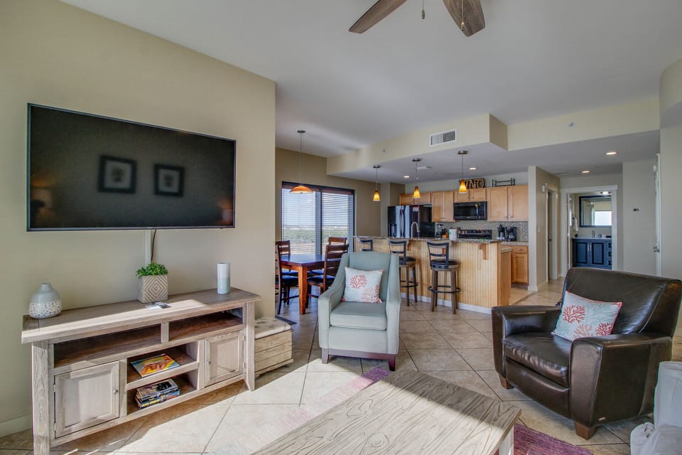 Unwind + enjoy the sunset from this comfortable living area! Complete with Smart TV + board games for the family!