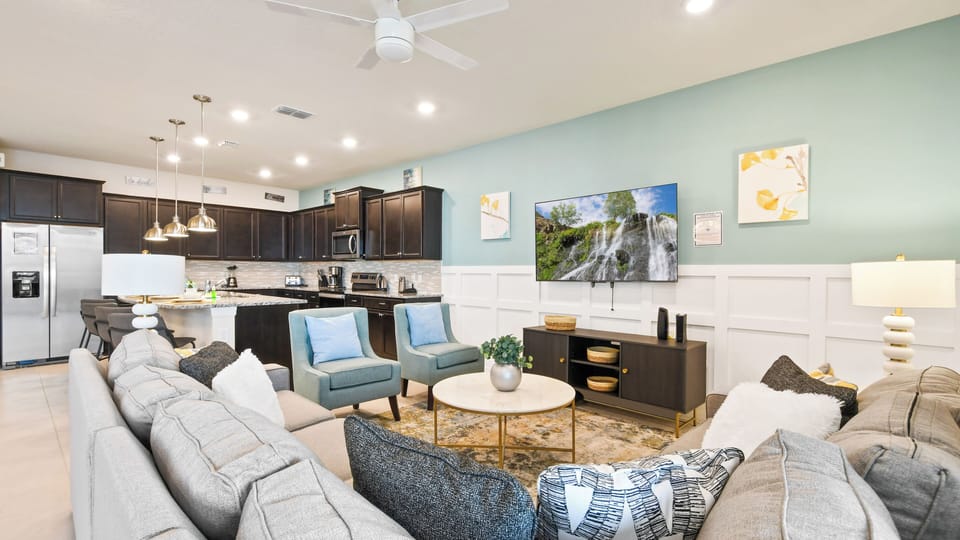 Open-concept living area with a modern kitchen, cozy seating, and stylish decor.