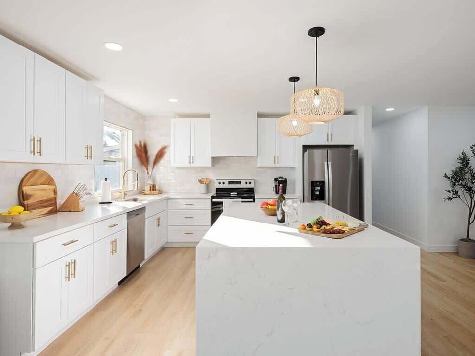 Bright Modern Fully Equipped Kitchen Stocked with your Basic Cooking Essentials featuring Stainless-Steel Appliances.