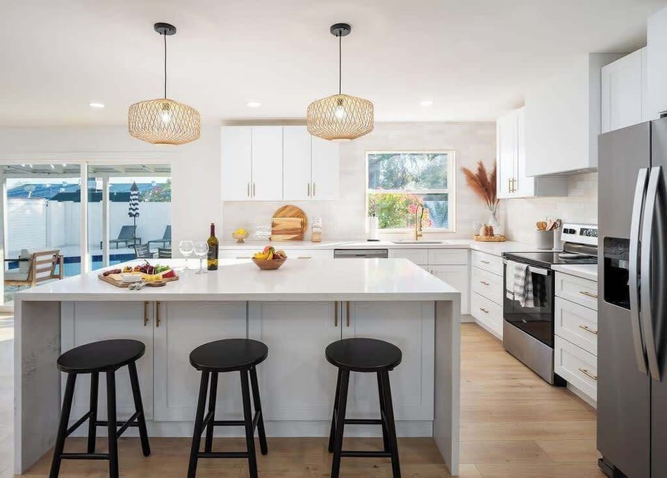 Bright Modern Fully Equipped Kitchen Stocked with your Basic Cooking Essentials featuring Stainless-Steel Appliances.