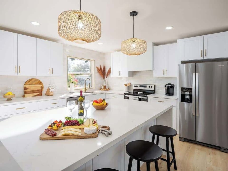 Bright Modern Fully Equipped Kitchen Stocked with your Basic Cooking Essentials featuring Stainless-Steel Appliances.