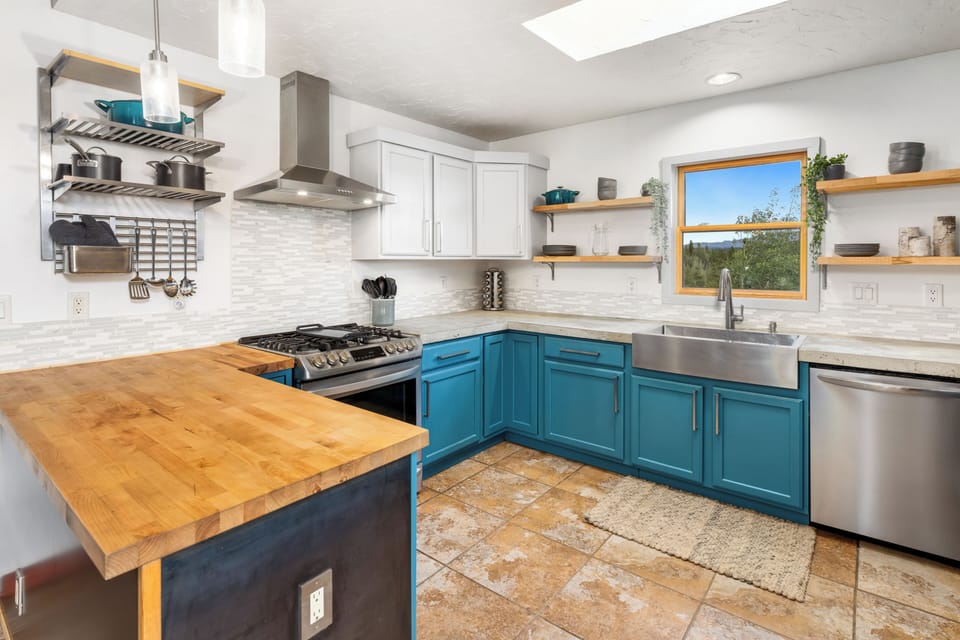 Gourmet kitchen with stainless appliances and breakfast bar.