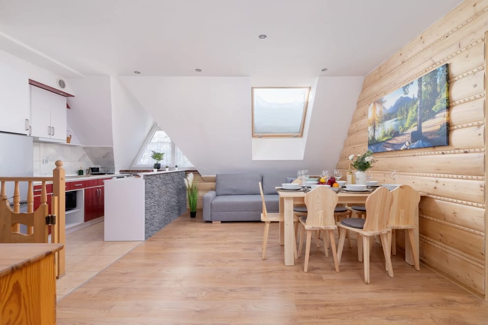 A spacious open-plan kitchen and dining area with wooden accents.

