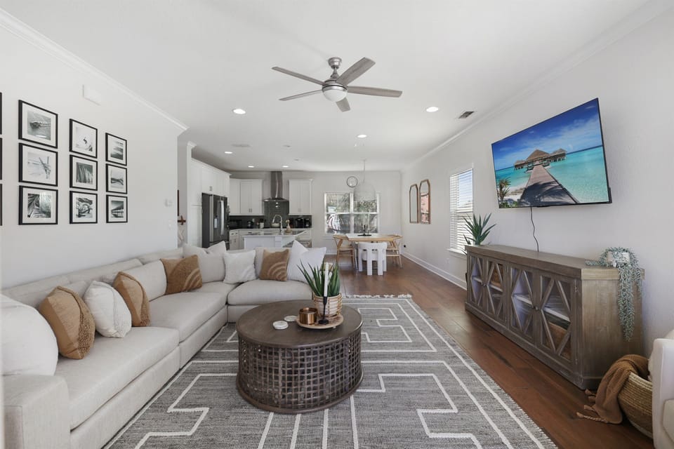 Spacious living room ideal for family game night or watching a movie together.  Open sightlines connect the living, dining, and kitchen areas