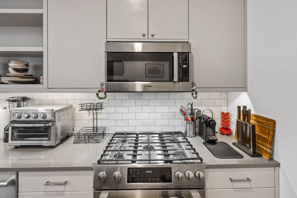 Full kitchen with stainless steel appliances.
