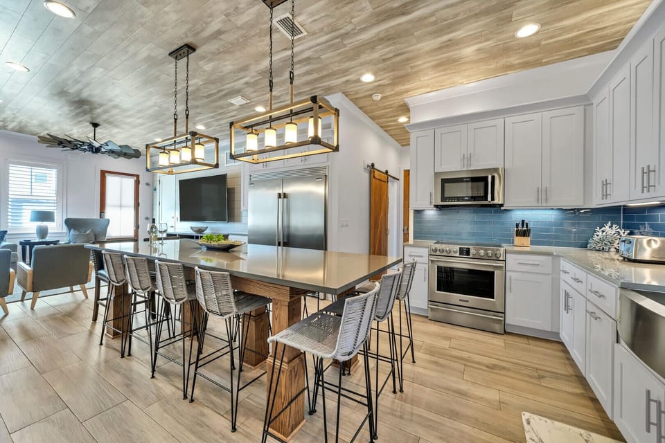 Open floor dining and living with views to the 86" Smart TV from the kitchen