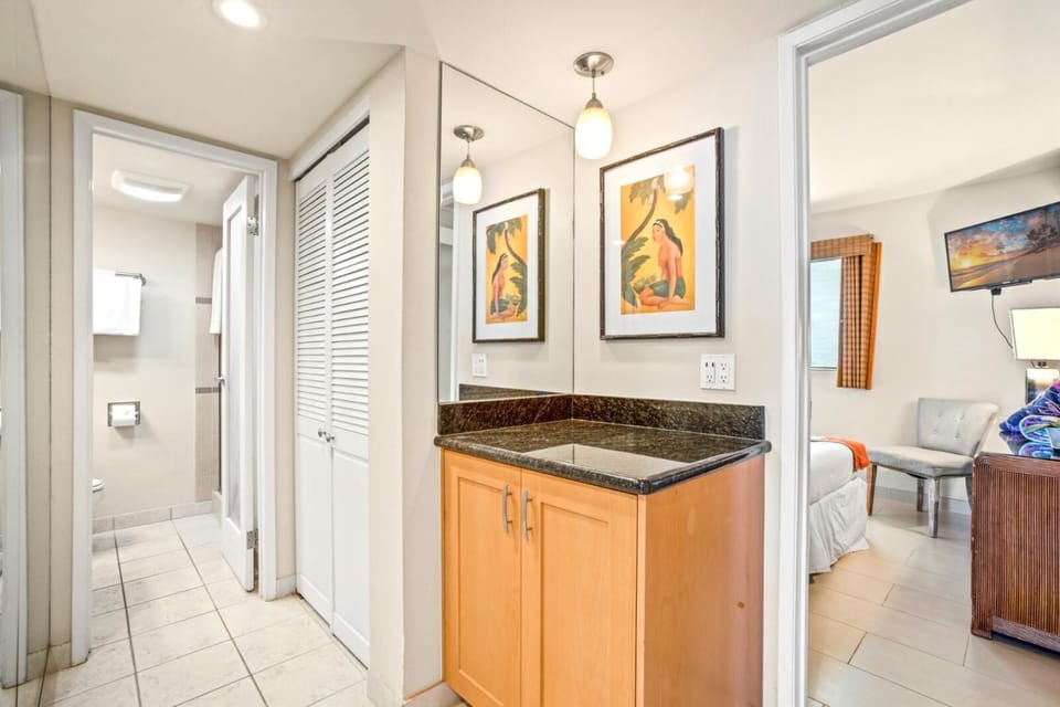     A serene guest bathroom with a walk-in shower, modern fixtures, and textured tile accents for elevated comfort