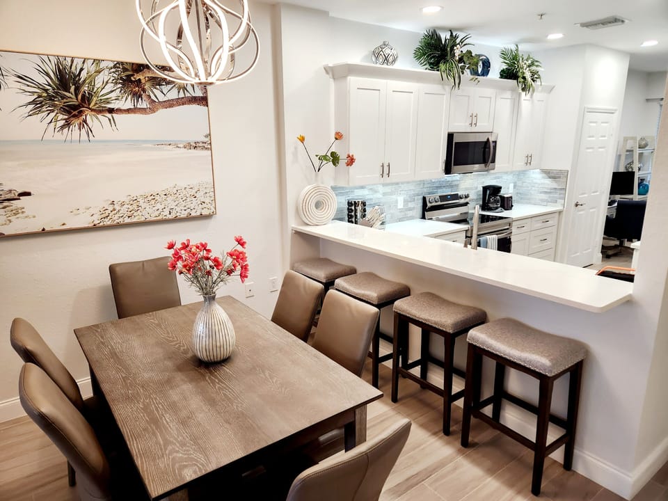 Dining room with bar seating behind kitchen