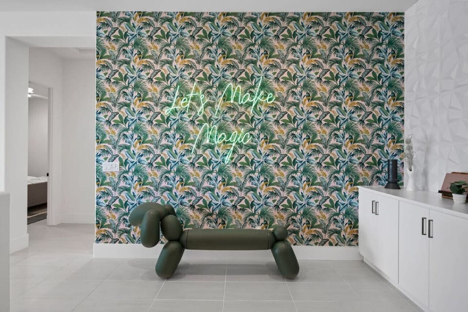 Chic entry nook w/ bold wallpaper & modern bench for a stylish welcome.