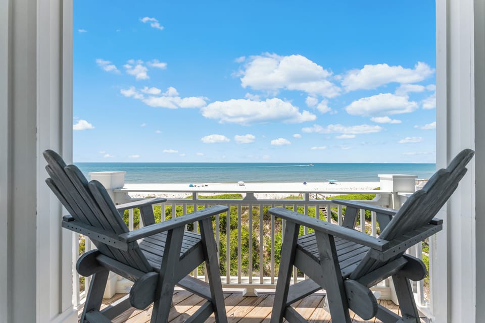 Step onto your private balcony where two Adirondack chairs await your morning coffee as you gaze across pristine turquoise waters.