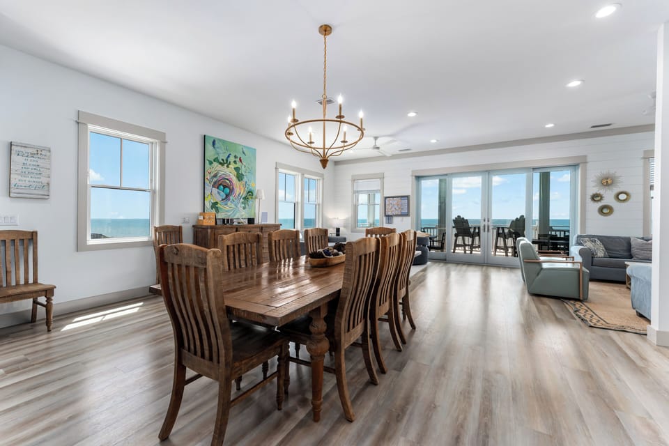Gather around this elegant dining table where family meals become cherished memories, with stunning ocean views creating the perfect backdrop.