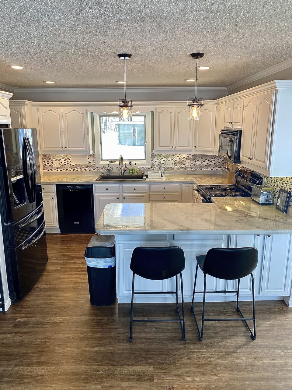 Plenty of kitchen counter space with barstools.  Dishwasher in the kitchen! 