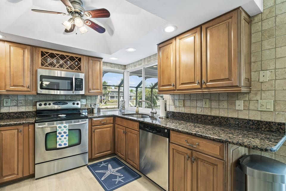 Enjoy Our Modern Electric Kitchen, Complete with Utensils, Small Appliances and Granite Countertops for Fun and Functional Cooking.