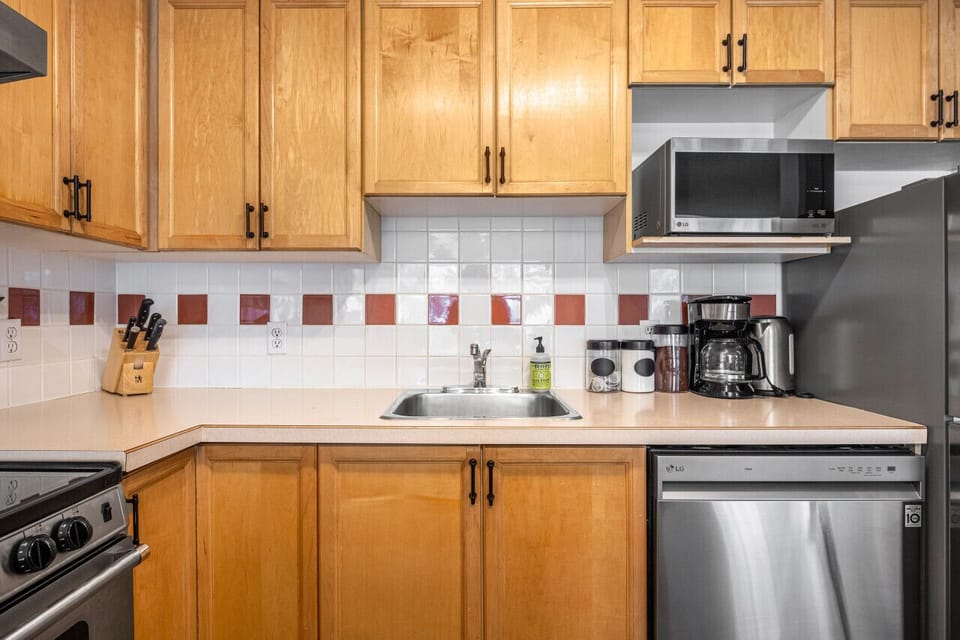 Full kitchen with a drip coffee machine, ground coffee, tea, sugar and basic condiments (ketchup, mustard and relish.)