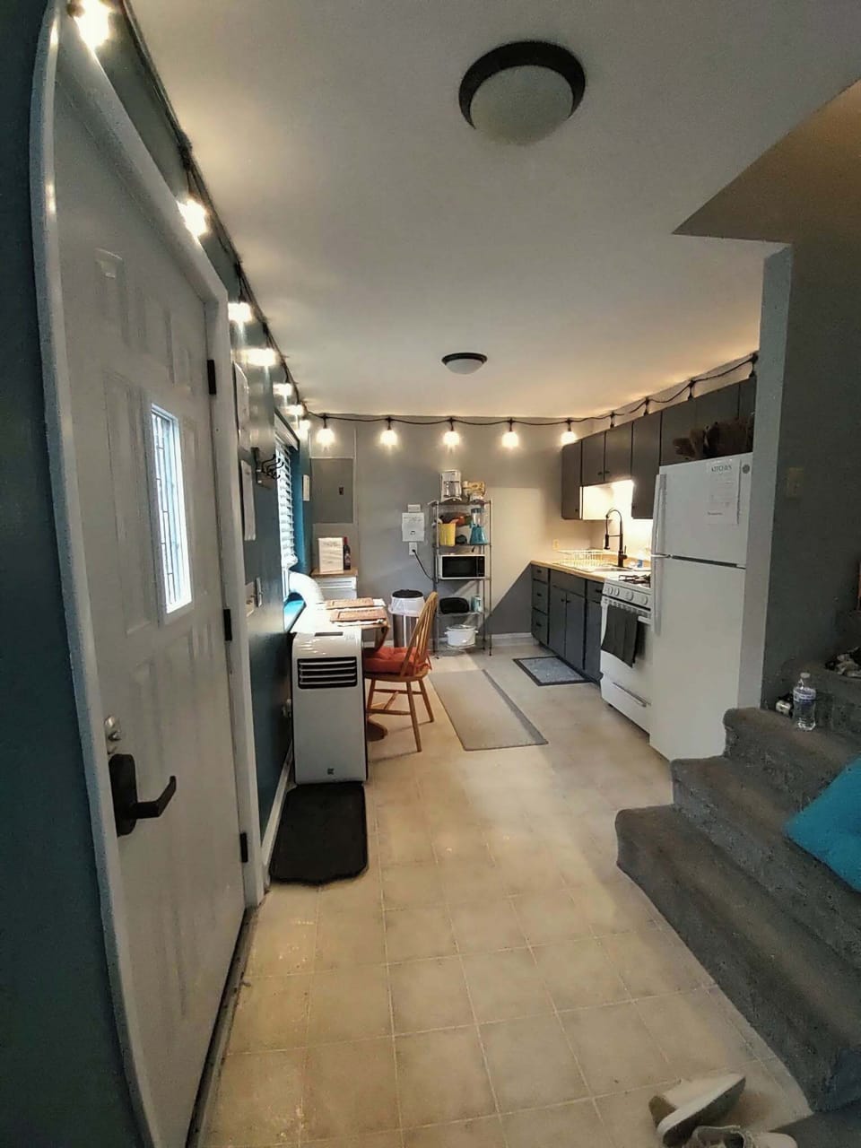 kitchen visible,interior staircase, stovetop, dining table, front door 
