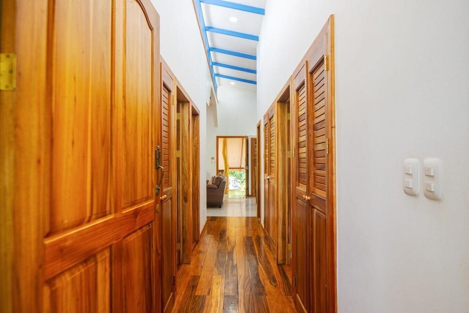 Interior hallway with hardwood floors, high ceilings, and easy access to all bedrooms, Blue Maverick in Puerto Viejo.