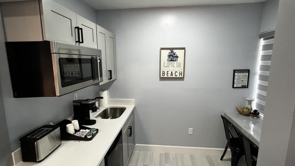 Kitchenette is equipped with mini fridge, microwave, toaster, coffee machine