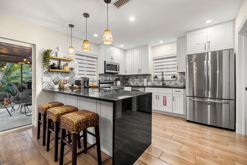 Fully updated kitchen with large island facing patio and pool. 