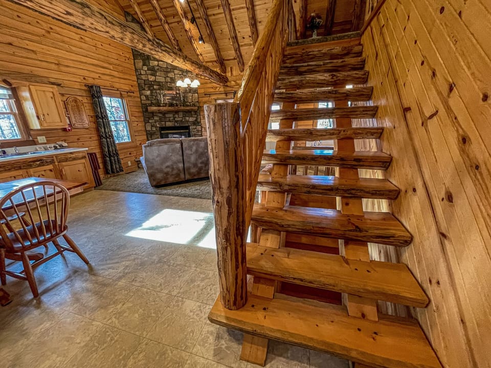 Half log steps leading up into the loft bedroom.