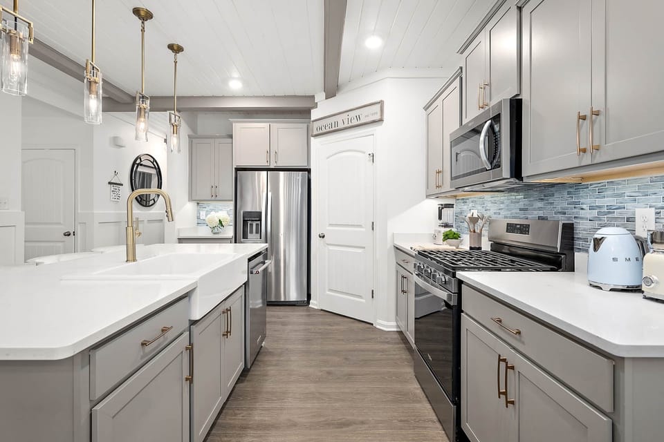 The kitchen is stocked with luxury amenities including Smeg coffee appliances.