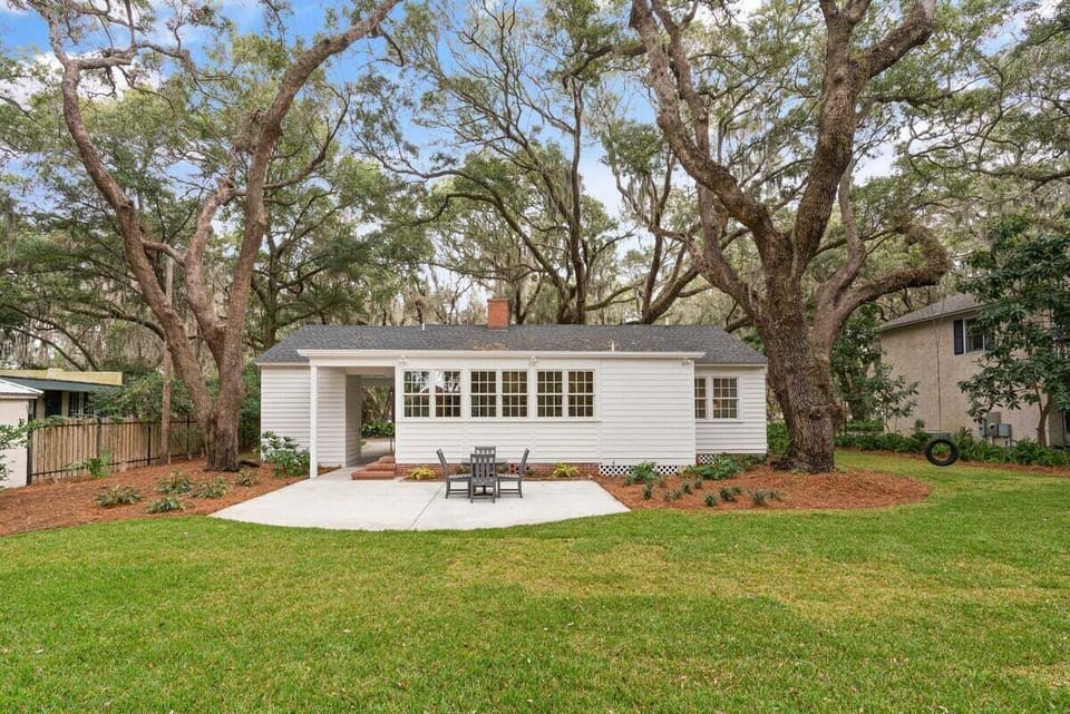Property exterior under large tree with patio