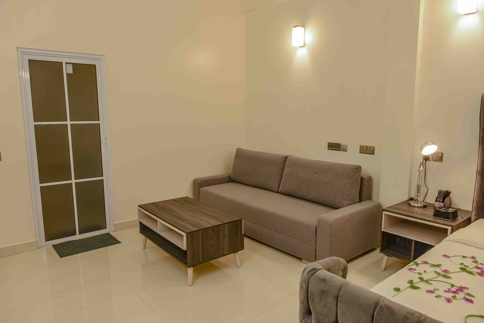 Deluxe Room, 1 King Bed with Sofa bed | Living area | Flat-screen TV