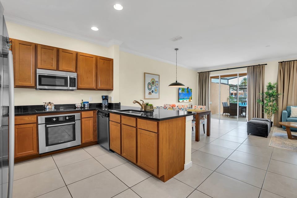Large, open kitchen with stainless appliances and solid surface countertops