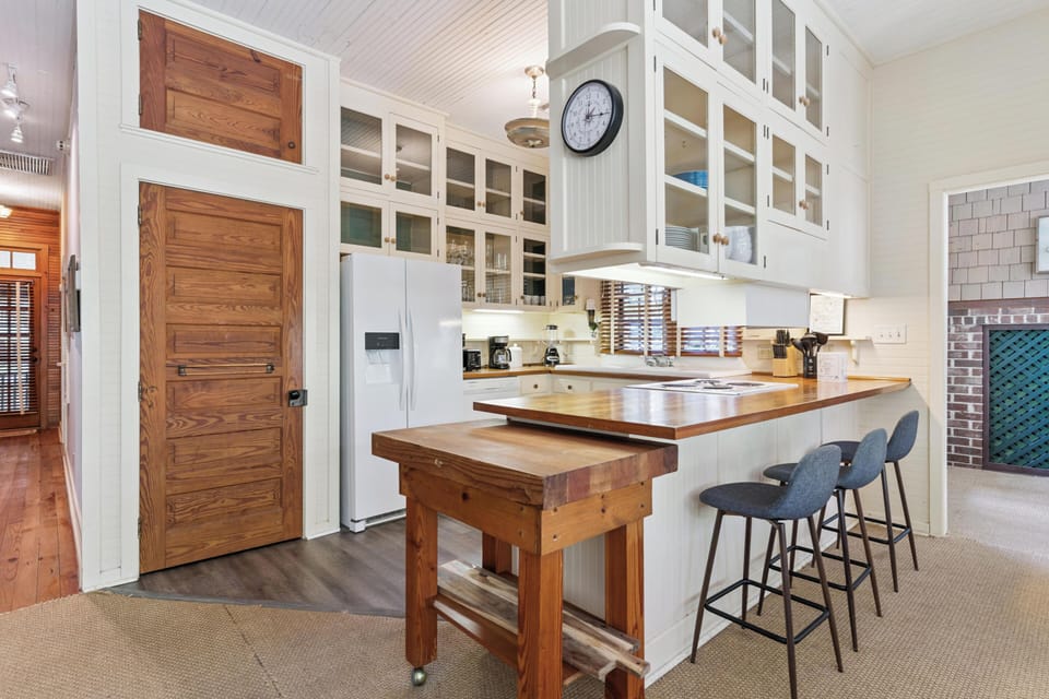 Your spacious kitchen awaits with gleaming countertops, modern appliances, and a charming breakfast bar for morning coffee rituals.