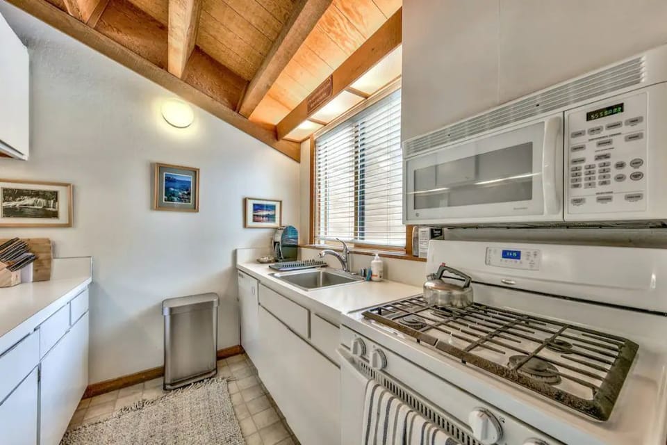 Kitchen with gas stove, oven, microwave and Keurig coffee maker.