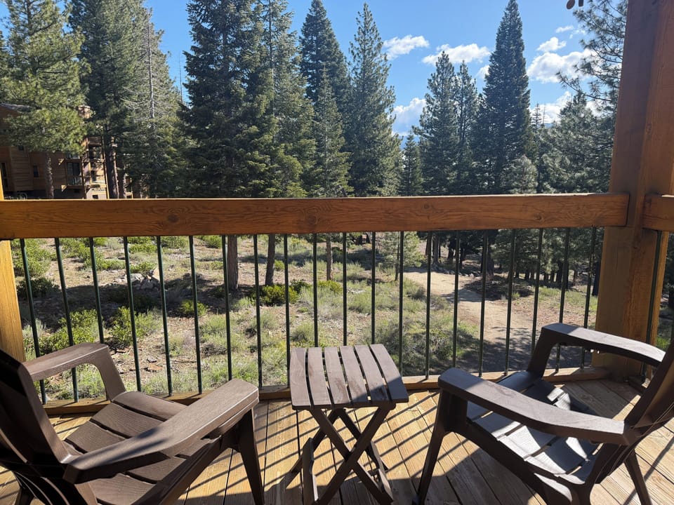 Upstairs Deck overlooking wooded forest and trailheads..