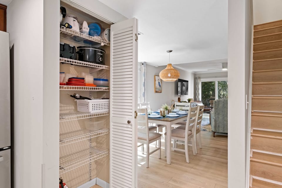The pantry contains a waffle maker, crock pot, blender, grilling tools, & more.