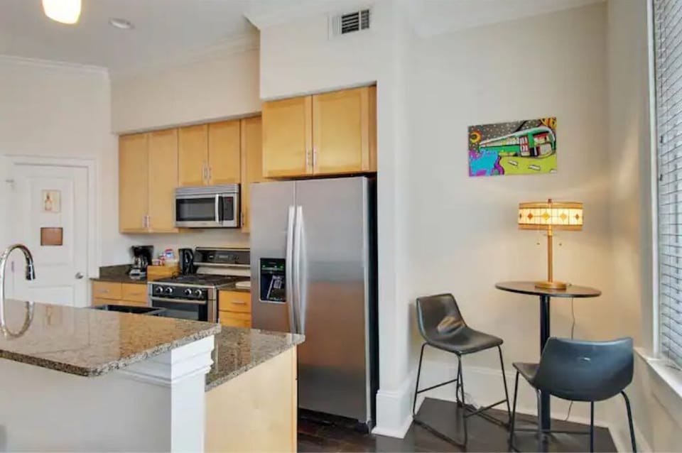 Modern kitchen equipped with stainless steel appliances and granite countertops.