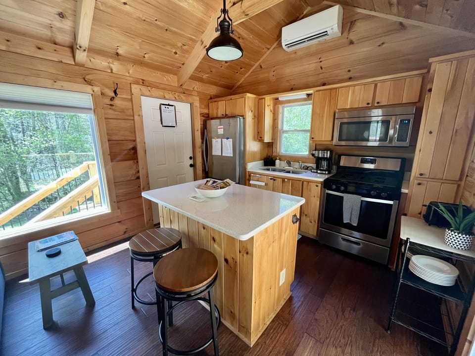 Kitchen includes tea kettle, coffee maker, spacious fridge, and dishwasher