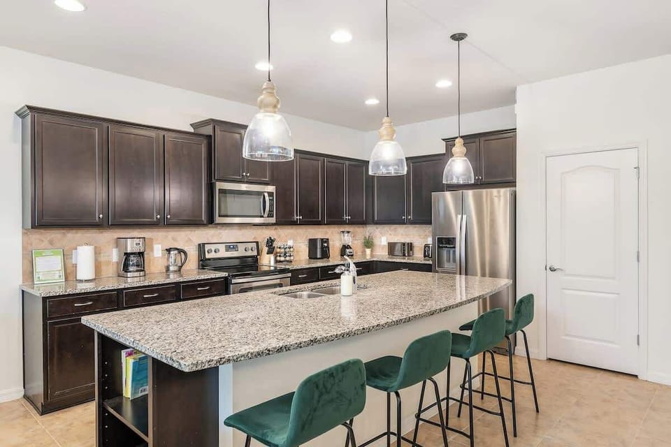 Fully Stocked Kitchen with large island and seating for four.