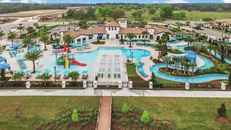 Windsor At Westside Resort aerial view includes lazy river, pool, and kid's splash pad.