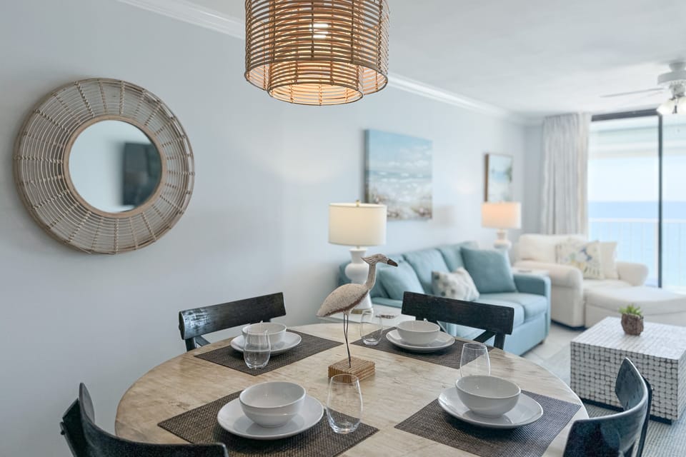 Light and airy dining space featuring coastal-inspired decor and a seamless flow between the kitchen and living areas.