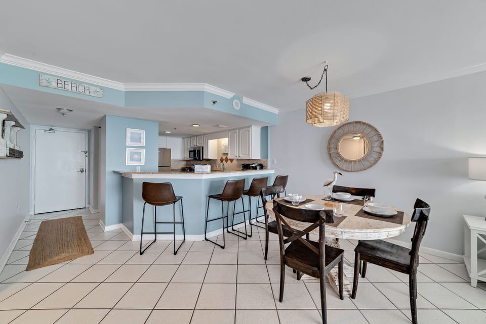 Flexible dining options for every occasion. Enjoy a formal meal at the dining table or a casual snack at the breakfast bar, seamlessly connected to the fully equipped kitchen.