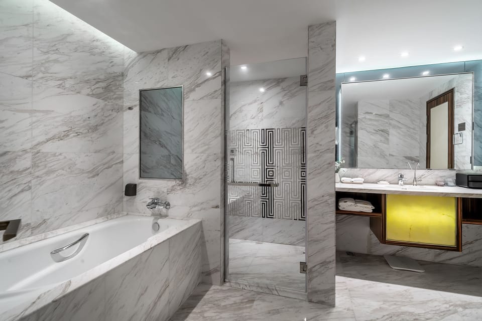 Elite Suite, 1 Bedroom, City View | Bathroom | Combined shower/tub, rainfall showerhead, free toiletries, hair dryer