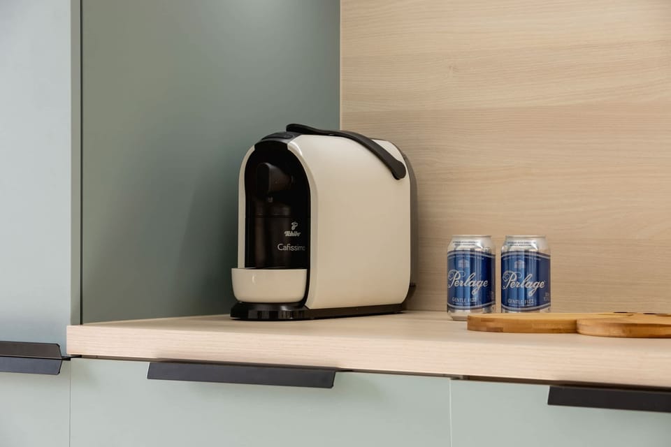 A close-up of a coffee machine and mugs, adding convenience for guests.
