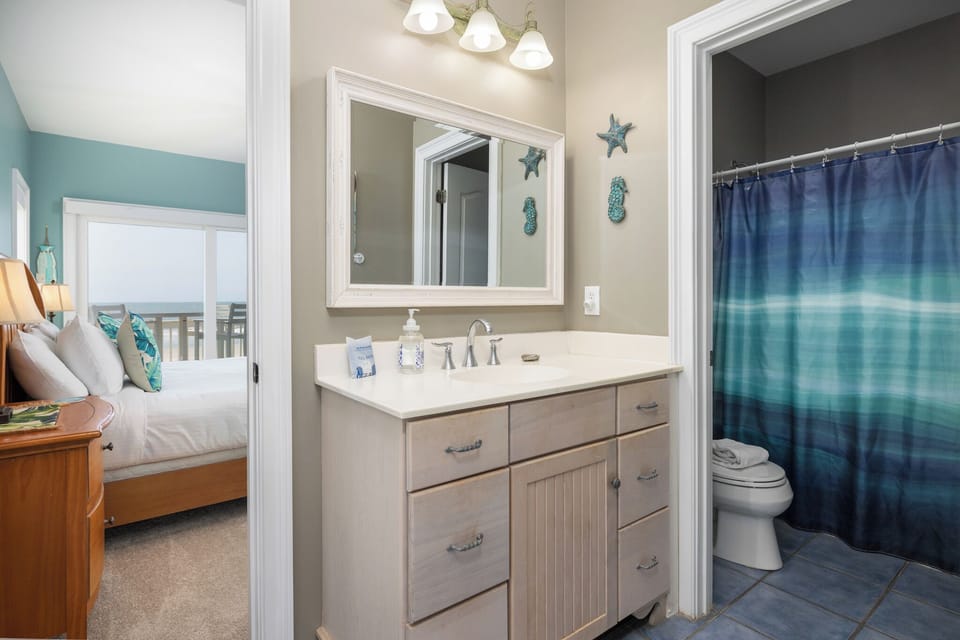 Your downstairs king bedroom features an en suite bathroom with tub-shower combo